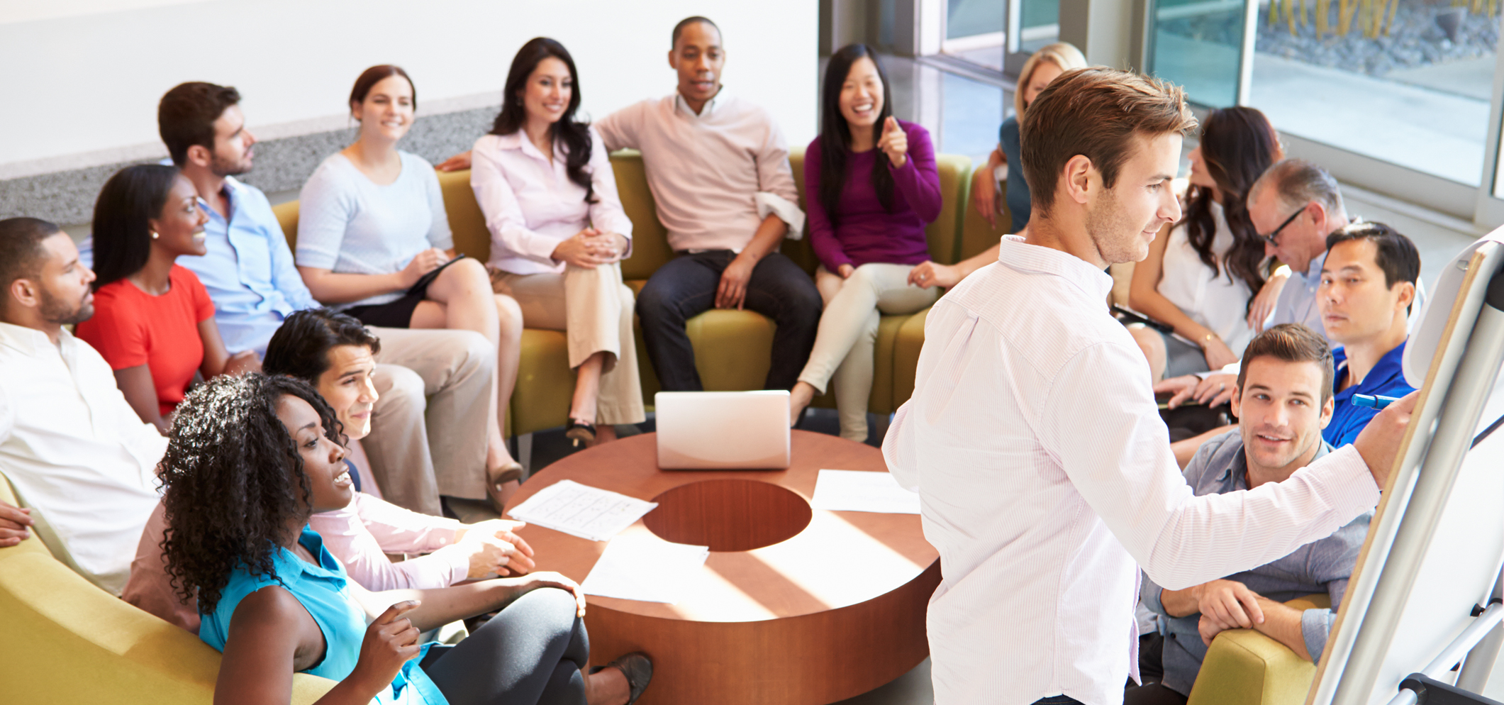 A businessman making presentation to multi-ethnic collegues