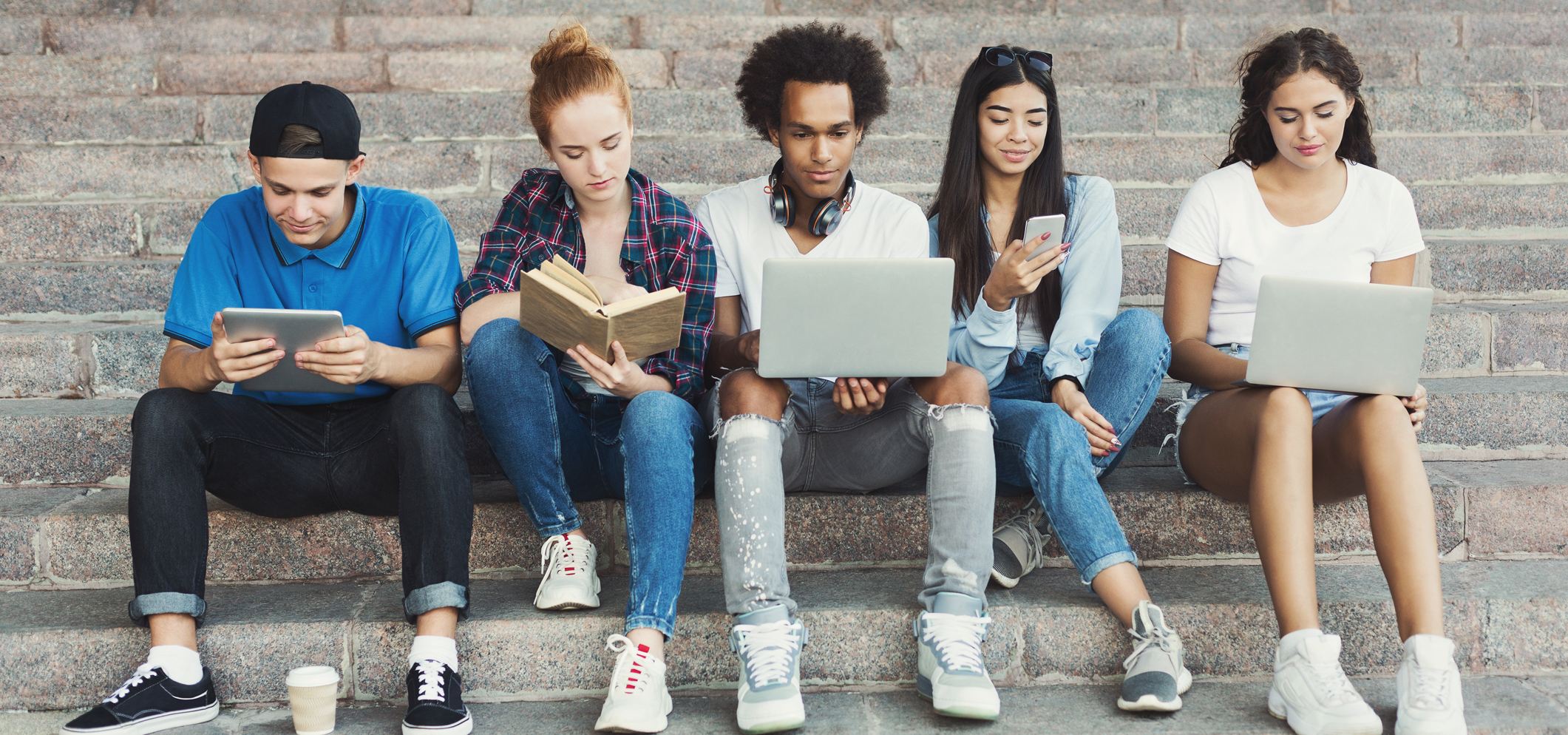 Multi-Ethnic High School Students Working On Campus With Teacher